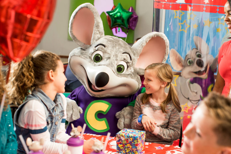 Chuck E Cheese celebrating a birthday with 2 kids