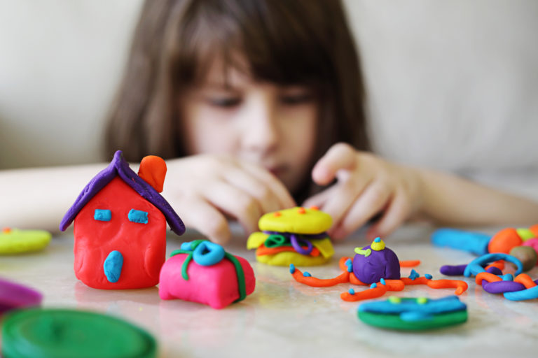 girl playing with clay