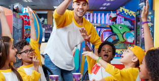 Coach and team eating at Chuck E. Cheese